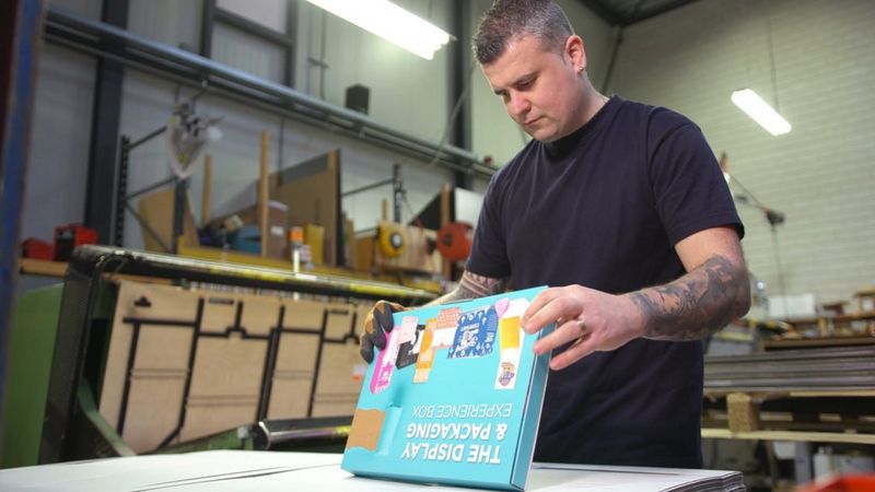 PPD employee looking at packaging printed on the Colorado with UVgel