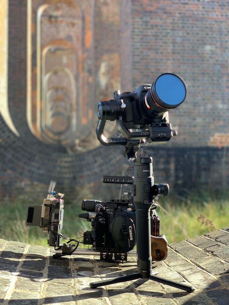 A Canon EOS 5D Mark IV on a tripod with a Canon EOS C200 behind, under the arches of the Balcombe viaduct.