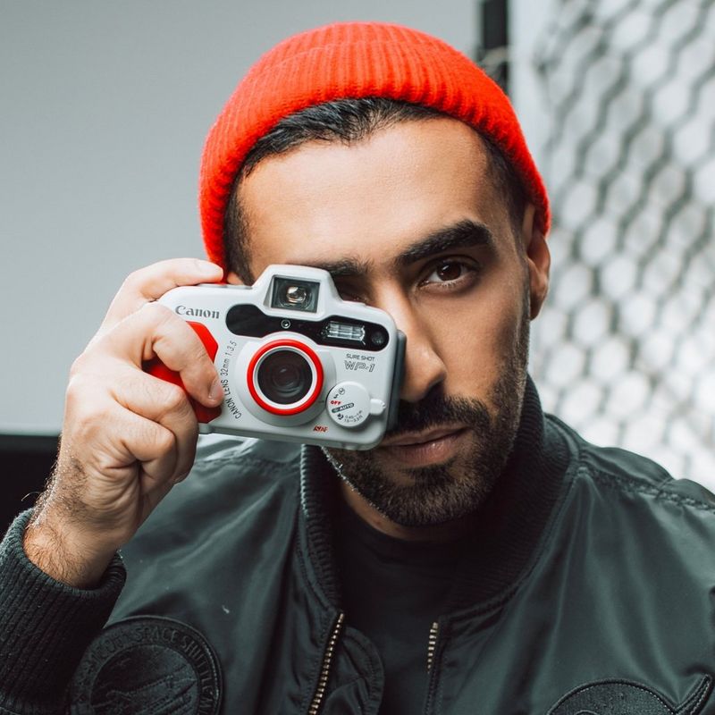A headshot of Canon Ambassador Abdulaziz Alsorayai holding a Canon camera.