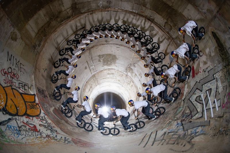 A composite image showing a BMX rider’s trajectory around the inside of a pipe.