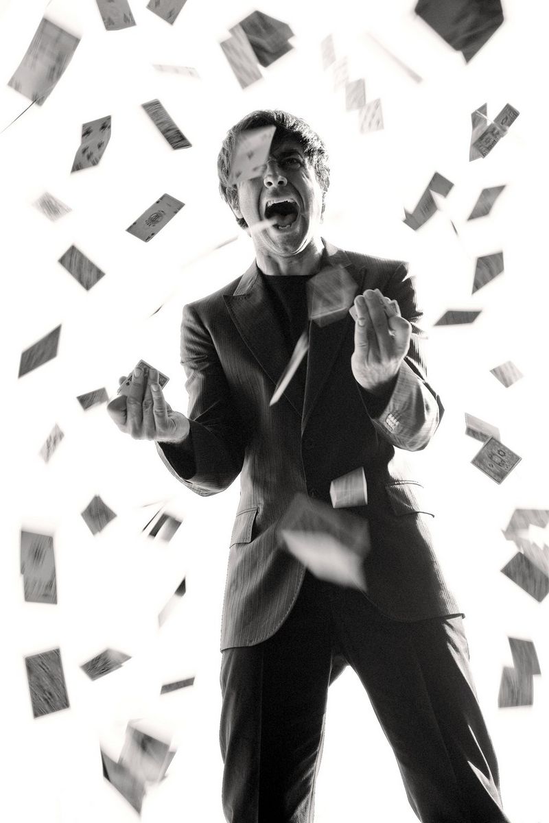 A black and white portrait of Turkish actor Cansel Elçin surrounded by playing cards apparently flying through the air. Taken on a Canon EOS 5D by Cem Talu.
