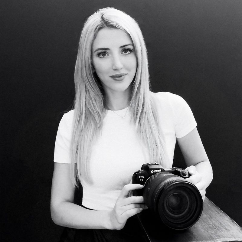 A black and white portrait of Canon Ambassador Donatella Nicolini holding a Canon camera.