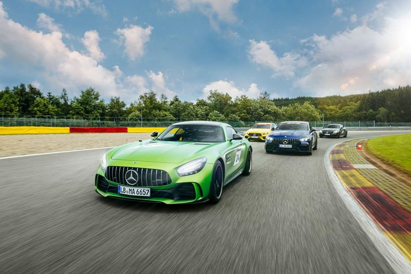 A green Mercedes on a race track, trailed by a blue, a yellow and a black Mercedes, taken on a Canon EOS R5 by Florian Roser.