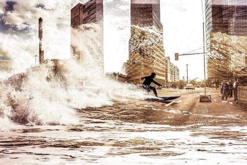 A double exposure of a surfer riding a wave into a street in Berlin, Germany.