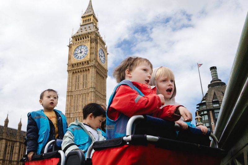 Children in buggies exploring London, with Big Ben in the background.