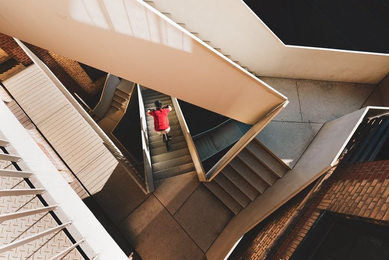 Shot from overhead, mountain biker Mario Neurauter descends a series of angular staircases in Basel, Switzerland.