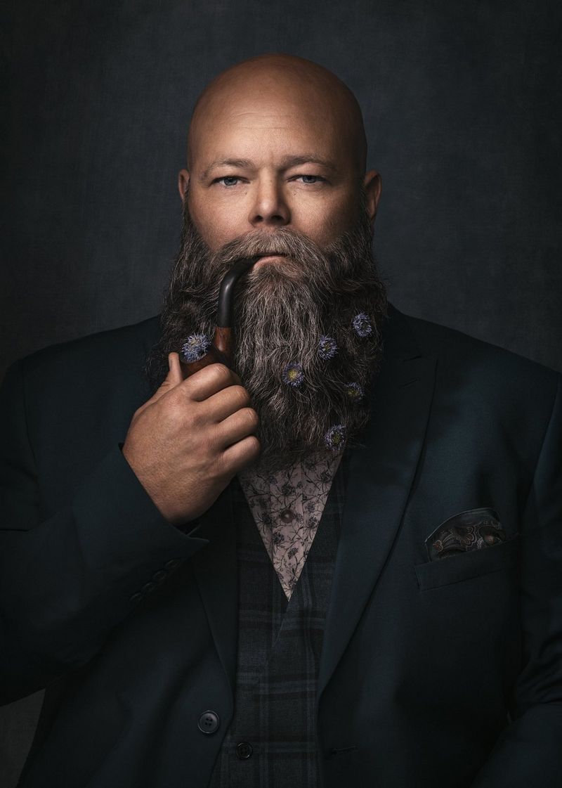 A softly lit portrait of a bearded man in a dark jacket taken on a Canon EOS R5 by Canon Ambassador Martina Wärenfeldt.