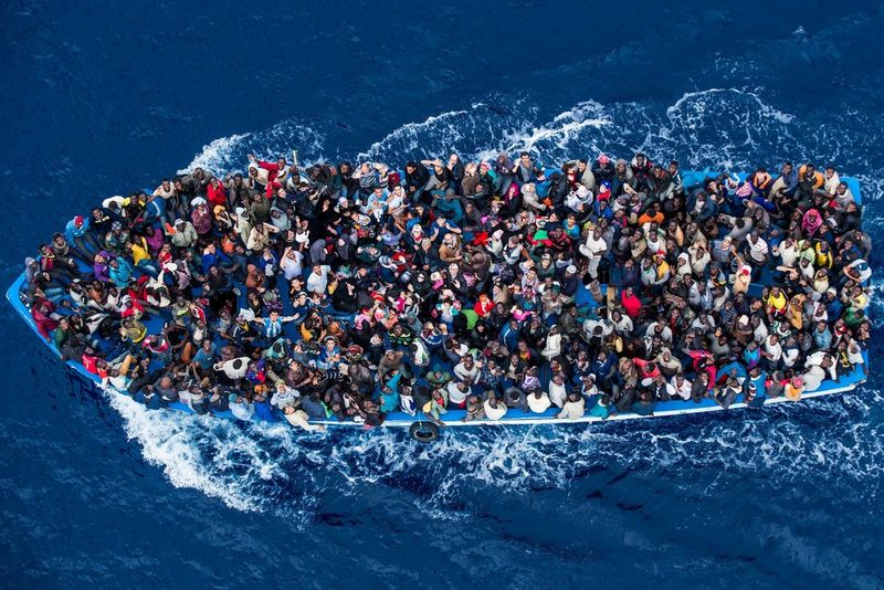 An aerial image of more than 500 refugees crowded together on a moving boat off the coast of Libya. 