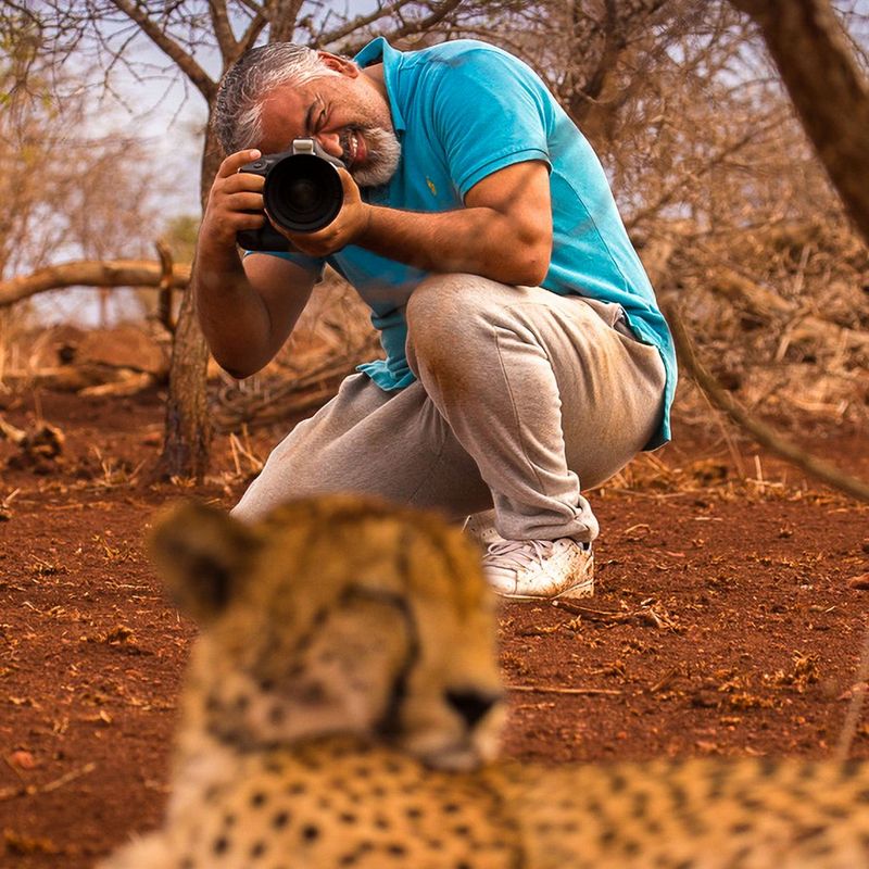 A portrait of Canon Ambassador Mohammad Murad photographing a cheetah with a Canon camera.