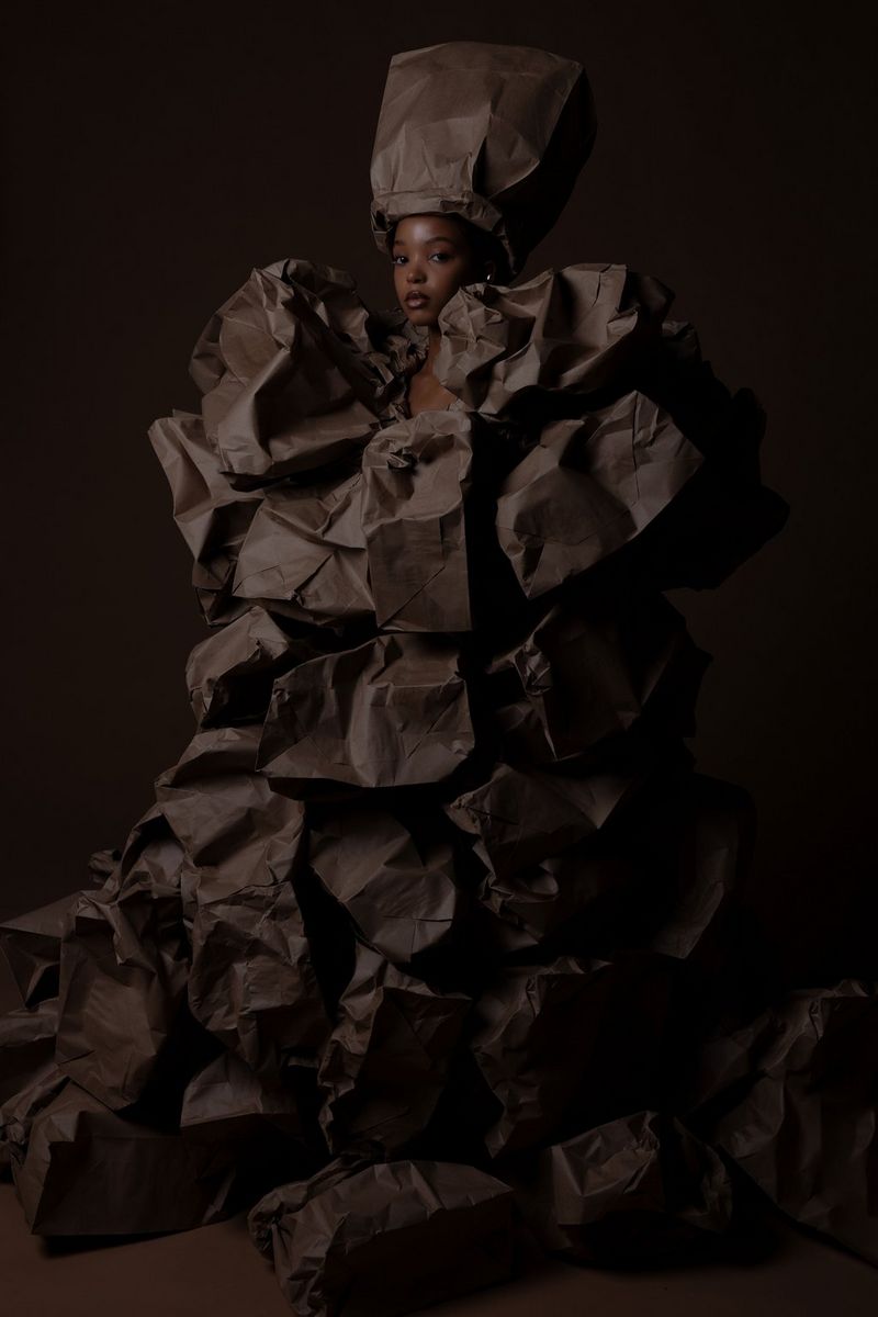 Modni portret modela u raskošnoj haljini s velikim šeširom u potpunosti izrađenim od smeđih papirnatih vrećica. Snimila Nina Zimolong modelom EOS R5 tvrtke Canon.