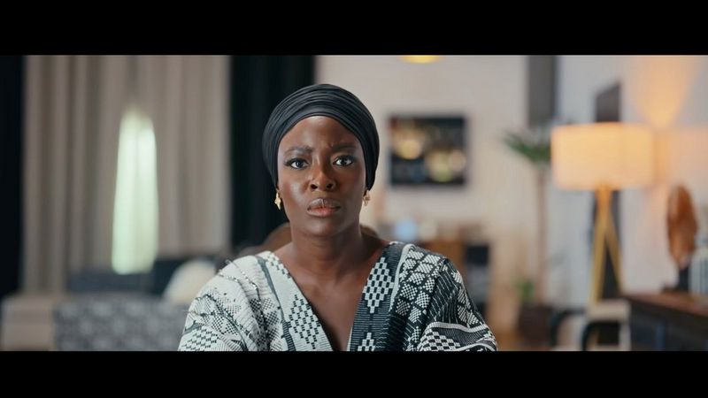 A woman stares directly at the camera with a concerned expression on her face. Still from Red Circle by Nora Awolowo.