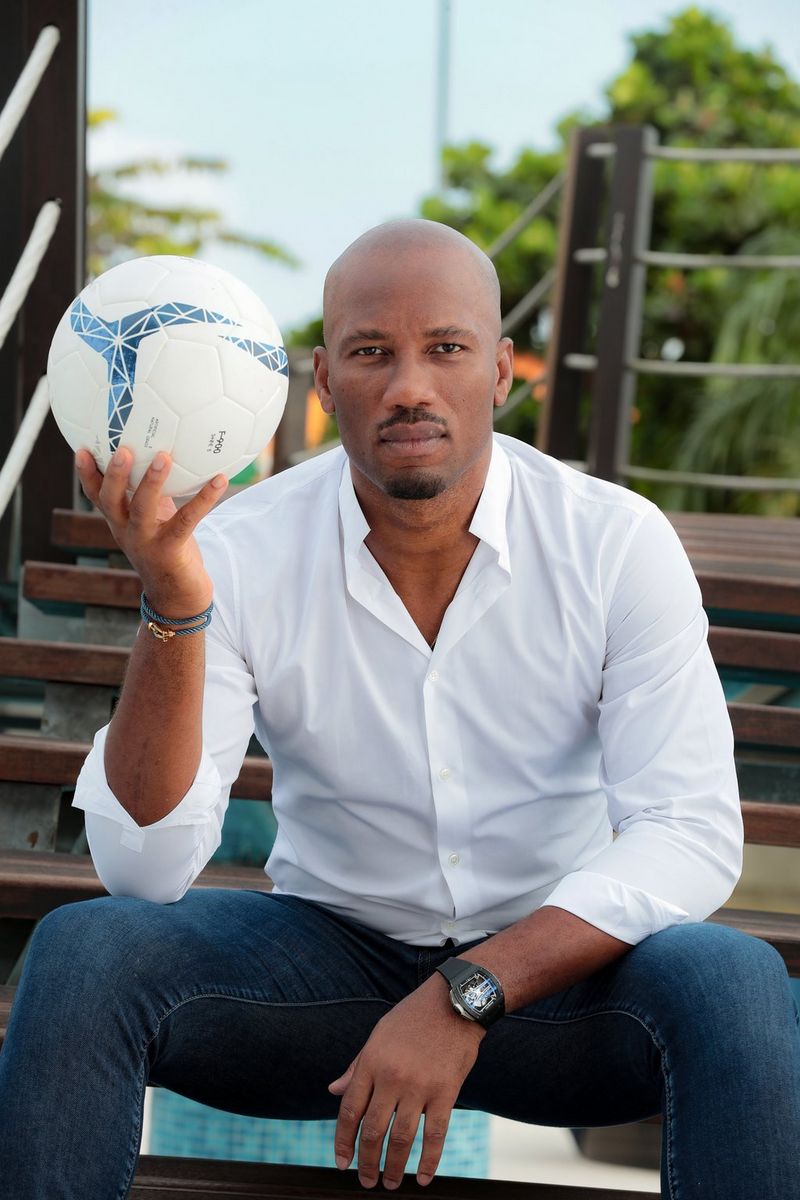 A portrait of footballer Didier Drogba holding up a football in his right hand. Taken on a Canon EOS-1D X Mark II by Canon Ambassador Seibou Traoré.