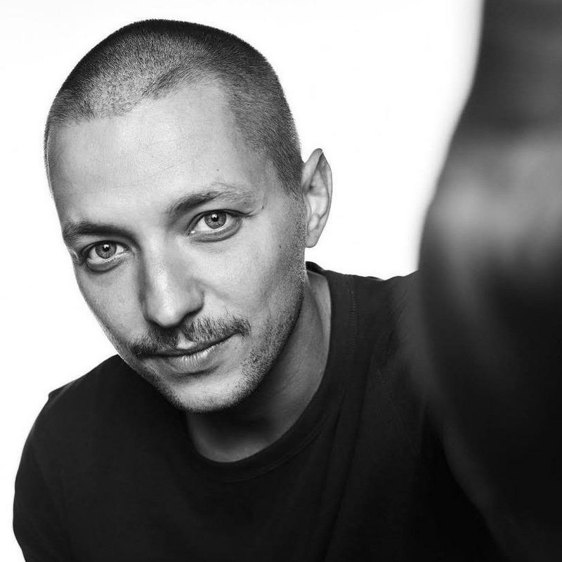 A black and white headshot of Canon Ambassador Szymon Dudka. 