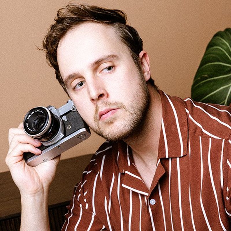 A headshot of Canon Ambassador Tristan Schäfer holding a Canon camera.