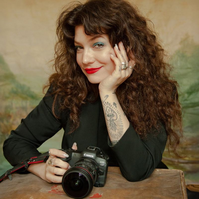 A portrait of Canon Ambassador Wanda Martin holding a Canon EOS R5 camera.