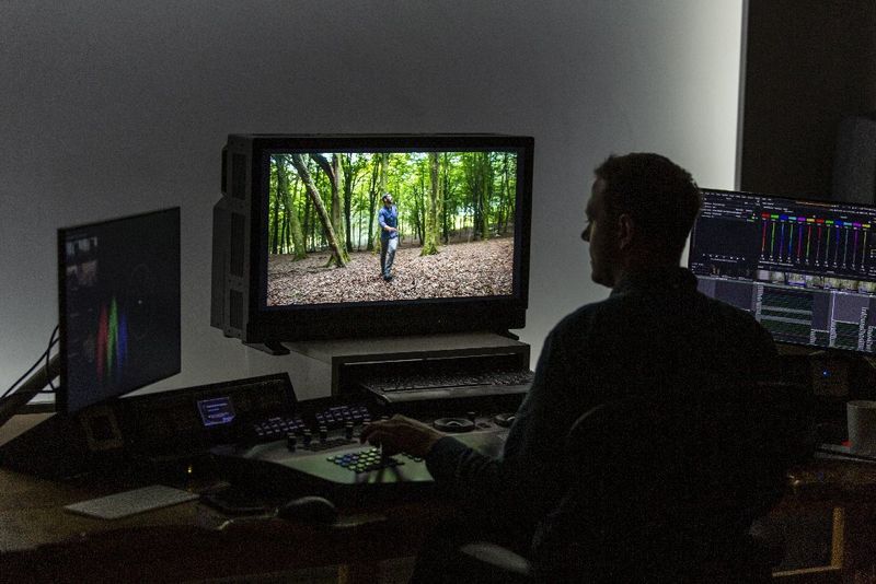 A computer in a video edit suite with two HD reference monitors.
