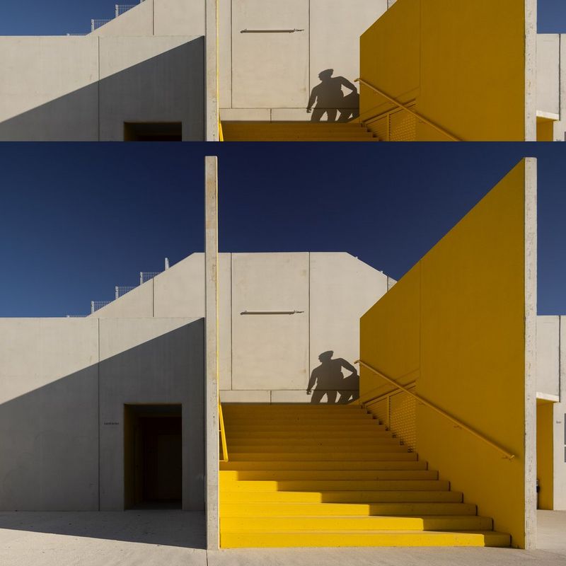 A yellow staircase on a building's exterior is pictured against a blue sky.