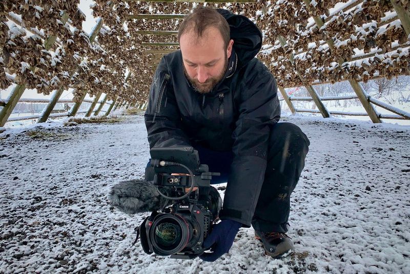 Roberto Palozzi films low to the snowy ground inside a huge wooden frame covered in air-drying fish.