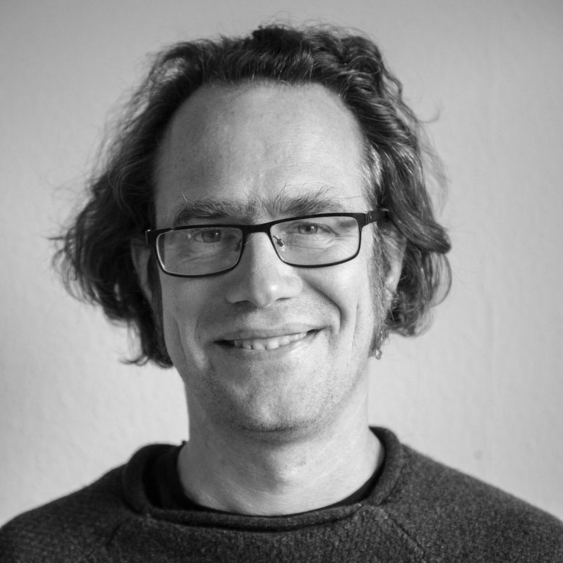 A black and white headshot of wildlife photographer Christian Ziegler.