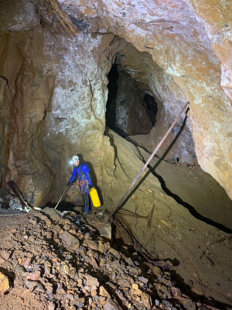 Filmmaker Daniel Simpkins on set down a mine, shooting with a Canon cinema EOS camera. 