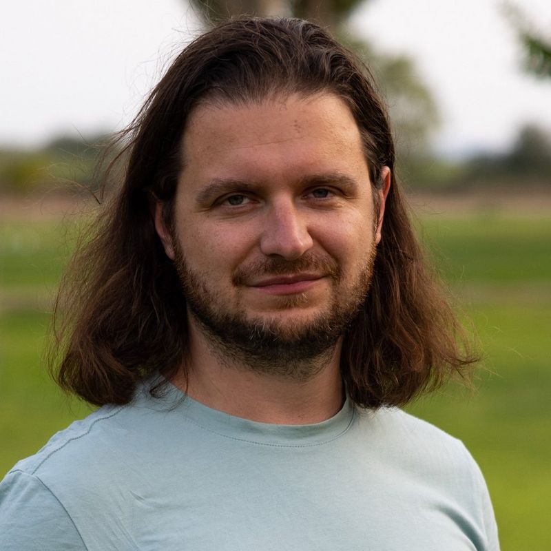 A headshot of photojournalist Michał Siarek.
