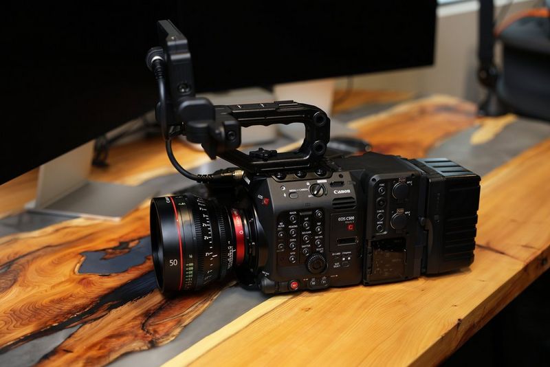 A Canon EOS C500 Mark II sits on a wooden table.