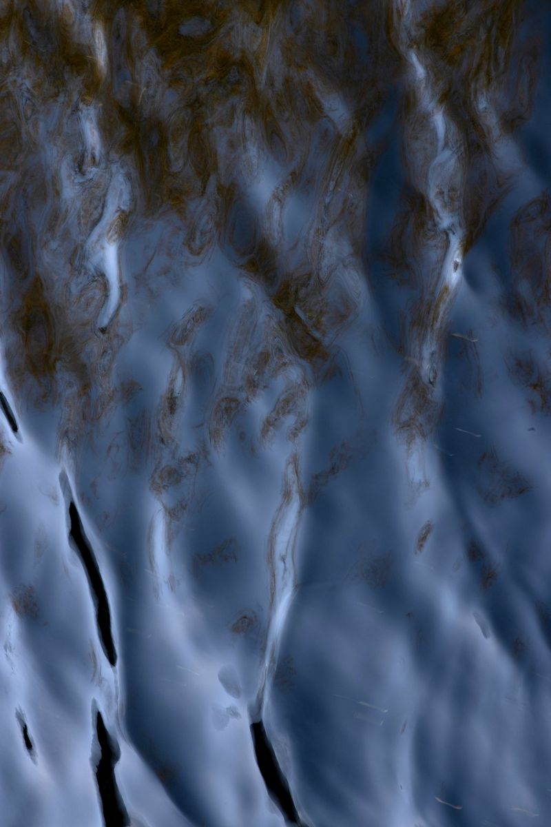 Ripples of inky-blue water smudged with dark patches.