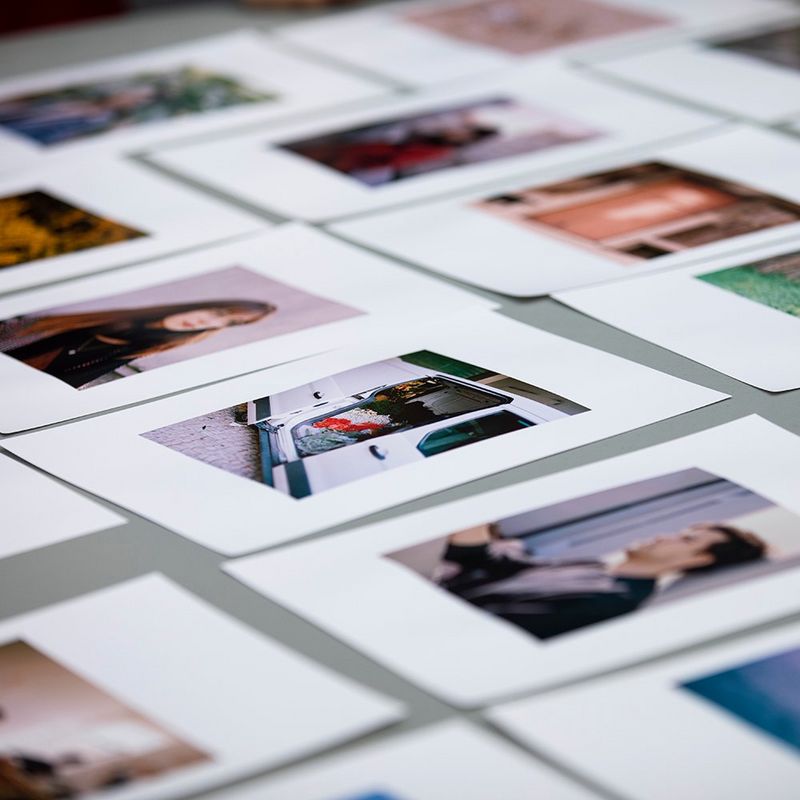 A selection of student portfolio images laid out on a table.