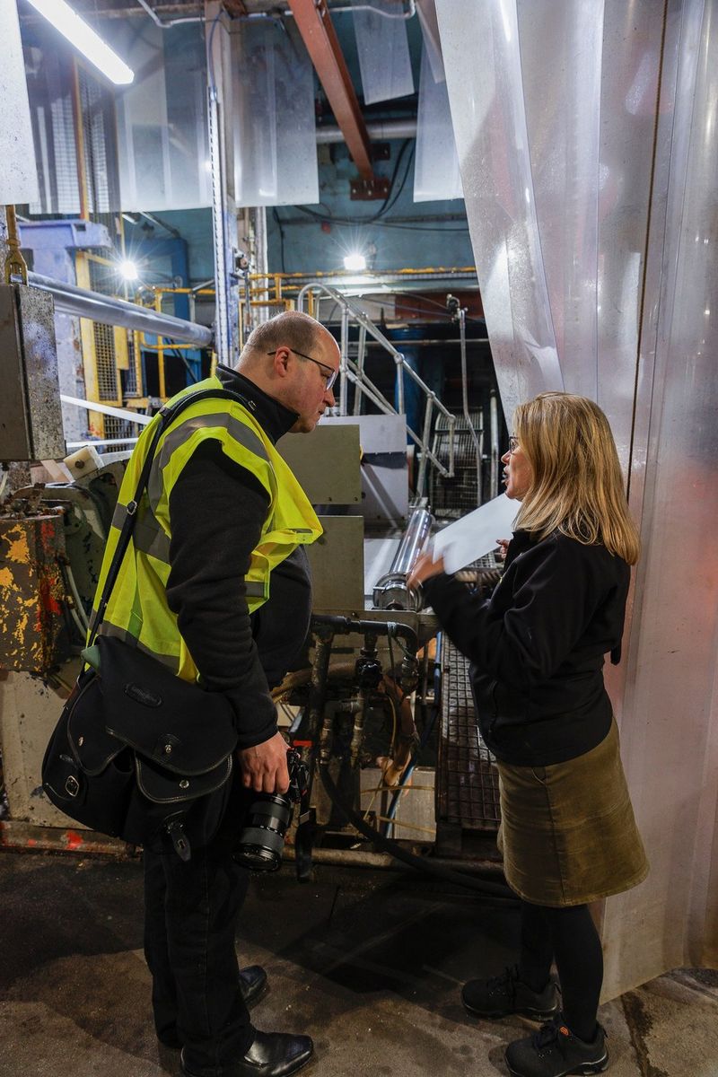 Catherine Frood provides a tour of St Cuthberts Mill, standing in front of paper making machinery. Shot on Canon.