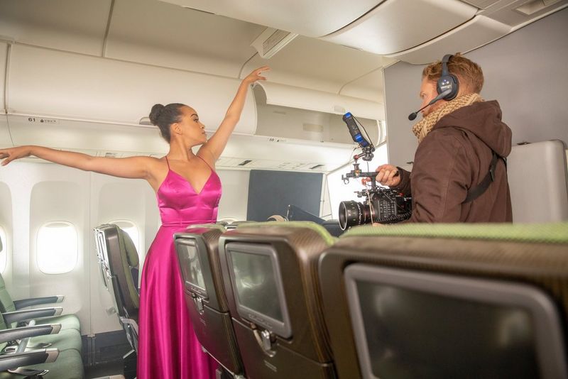Cinematographer Steve Holleran uses a Canon EOS C300 Mark III to film a ballerina in a fuchsia silk dress, performing in the aisle of a 747. 