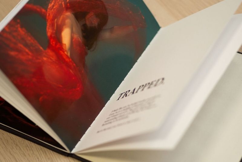 Two finished pages from a self-printed zine – the first featuring a young woman in a red dress, the second a supporting title and text.