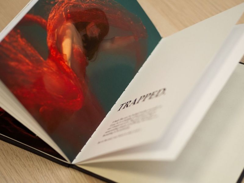 Two finished pages from a self-printed zine – the first featuring a young woman in a red dress, the second a supporting title and text.