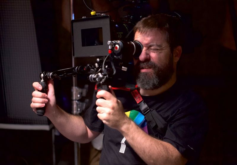 Filmmaker Juan Luis Cabellos filming using a shoulder-mounted rig.
