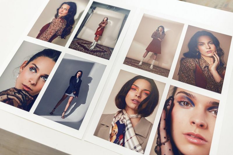 Prints from a fashion photoshoot are laid out, showing a dark-haired model in a variety of different outfits.