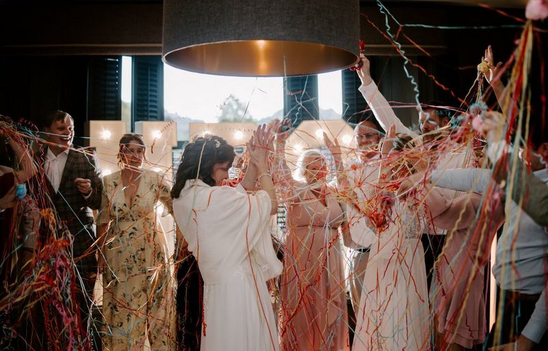 A lively wedding reception, with dancing guests entangled in colourful streamers, Taken on a Canon EOS R5 by wedding photographer and videographer Jo Greenfield.