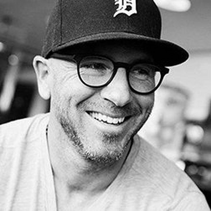 A black-and-white headshot of Magnus Wennman wearing a baseball cap. 