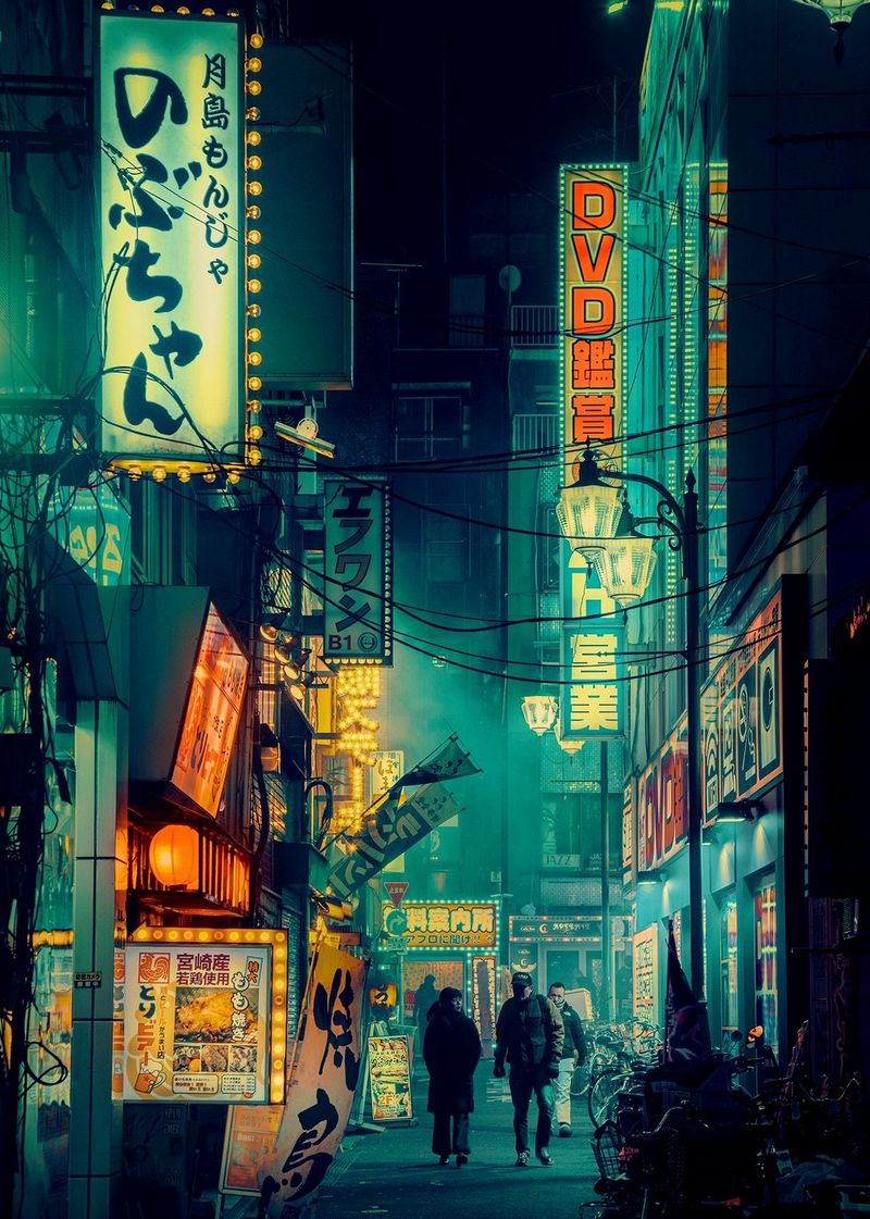 Two people walk down a neon-lit alleyway at night in Shinjuku, Tokyo. 