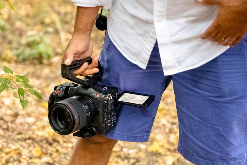 A man holding a Canon EOS C70 camera.
