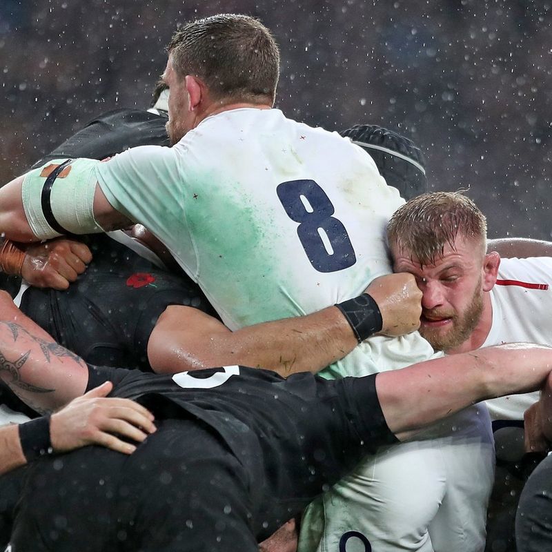 England and New Zealand rugby players in a ruck, photographed by Marc Aspland.