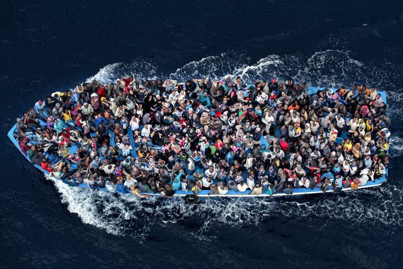 An aerial image of more than 500 refugees crowded together on a moving boat off the coast of Libya.