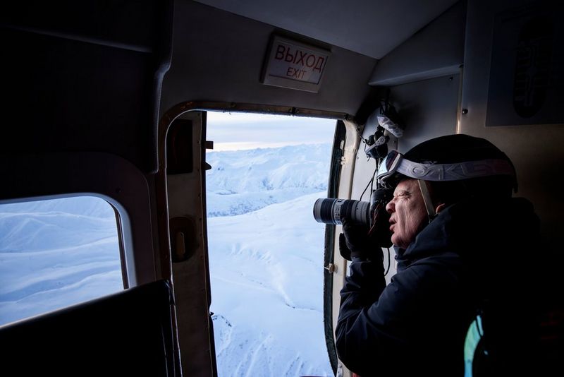 Action photographer Richard Walch photographs skiers from a helicopter.