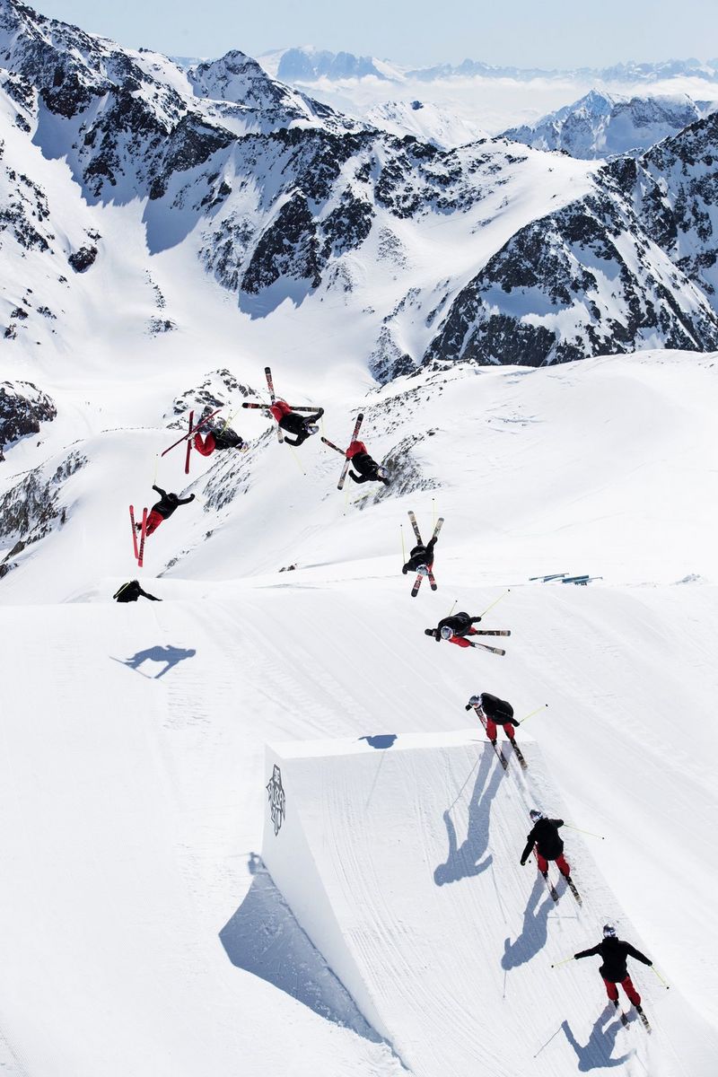 A multiple-exposure view of a skier executing a jump from a ramp, viewed from above.