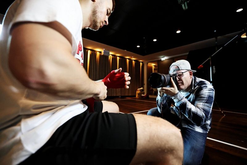 Action photographer Richard Walch photographs a seated boxer.