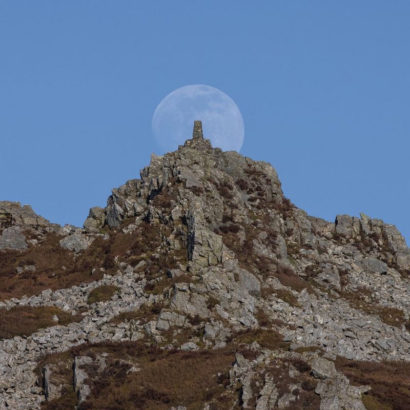The moon rising over Manstone Rock on the Stiperstones ridge in Shropshire, UK.