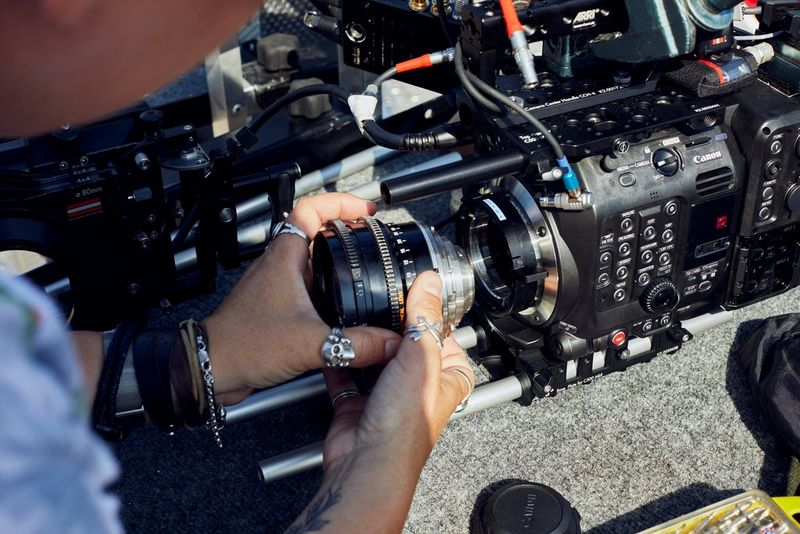 A filmmaker changing the lens on a Canon EOS C500 Mark II cinema camera. 