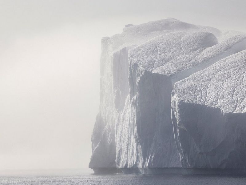 An iceberg on a misty day in Disko Bay, Ilulissat, Greenland, captured by Paolo Pellegrin on a Canon EOS R5.