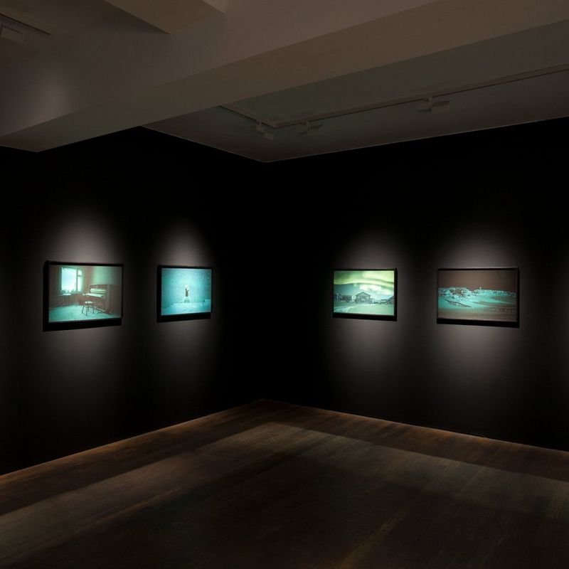 Fine art photographs mounted on the walls of a gallery.