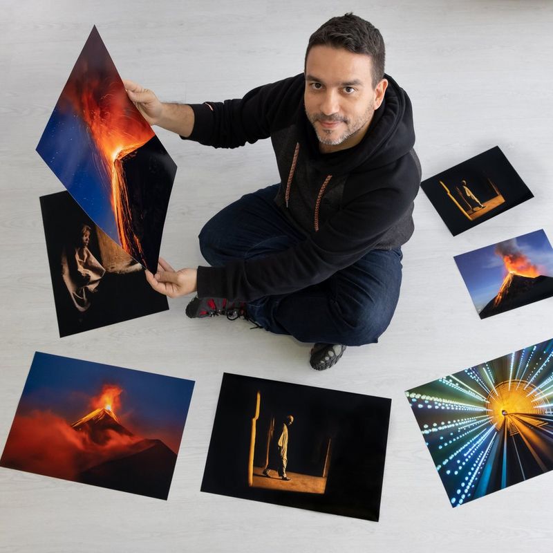 Canon Ambassador Joel Santos sits on the floor surrounded by photographs he has printed on a Canon PIXMA PRO-200.