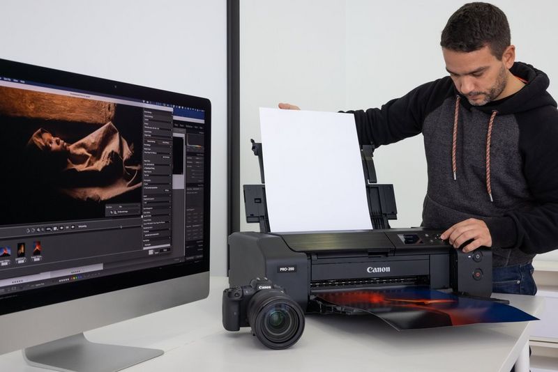 Photographer Joel Santos adjusts the settings on his Canon PIXMA PRO-200 printer. 