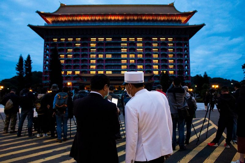A crowd in front of a building in Taiwan displaying the word 'zero', which relates to the number of Covid-19 cases recorded that day. 